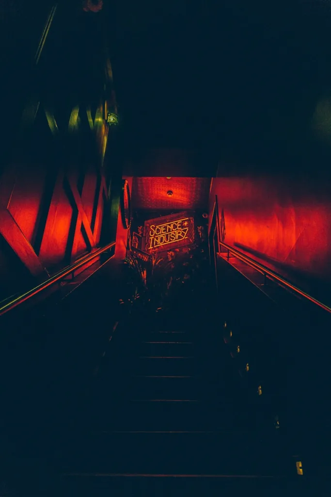 an escalator in a building with a red light